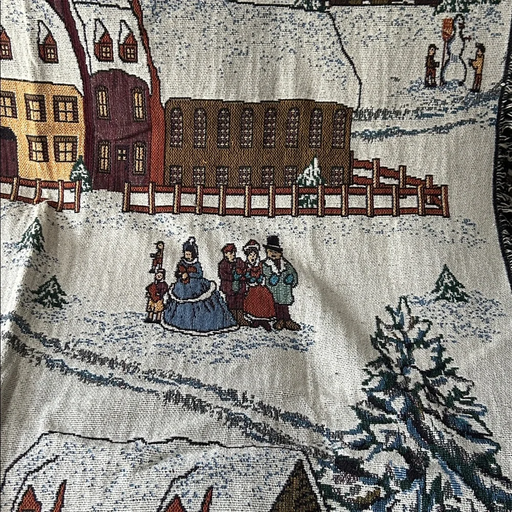 woven tapestry throw blanket featuring a winter village scene fringe edges